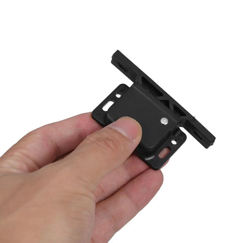 Hand holding black ABS RV Cabinet Latch Set 2 Pack Push To Close Drawer And Door Lock Grabber Catch for motorhome camper