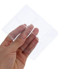 Hand holding Eight Pack Non Slip Silicone Furniture Feet Pads for chair legs and home furniture, transparent design.