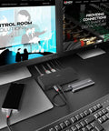 Top Tier Universal Laptop Docking Station With Triple 4K Displays And Display Port Outputs Usb C And A Hybrid Hub Five Superfast Ports No Hassle Plug And Play Workhorse Desk Upgrade on a black desk with dual monitors.