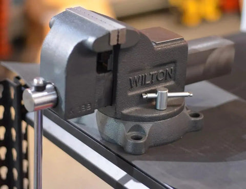 Heavy Duty 4 Inch Bench Vise With 360 Degree Swivel Base Double Lockdowns 4 Inch Jaw Width mounted on a workbench