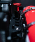 Close-up of the Slick Under Seat Fire Extinguisher Bracket For Ineos Grenadier Truck with red release knob and secure straps.