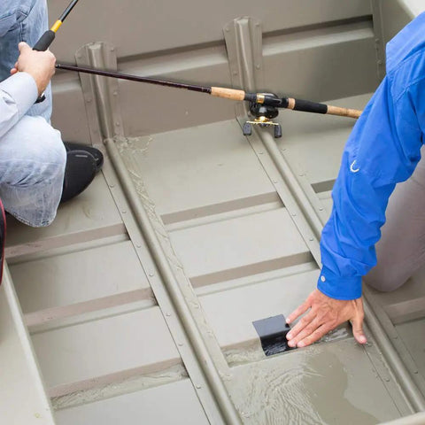 Person applying Mini Black Rubberized Waterproof Tape For Quick Seals And Patches on a boat to seal a leak.