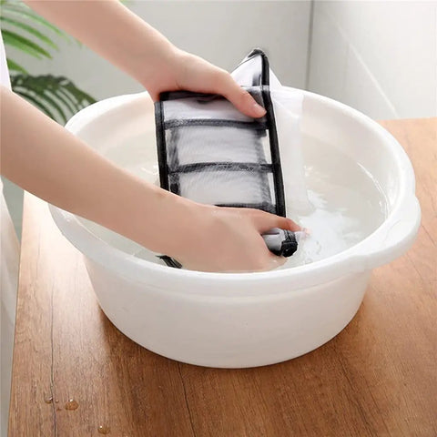 Washing a Slick Nylon Mesh Drawer Divider Set For Bras Socks And Lingerie Dresser Sorting Bins in a bowl of water.