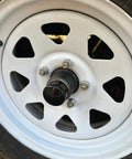 2-inch rubber wheel hub bearing dust cap plug (2-pack) on a white steel trailer wheel