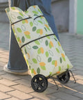 Person pulling a colorful shopping cart with 2 pack heavy duty shopping cart wheels replacement for trolley carts.