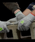 Top Shelf ANSI A4 Cut Resistant Work Gloves With Smooth Polyurethane Grip And Durable DuraBlend Shell Built Tough For Grease Monkey Tasks Providing Rock Solid Level 5 Abrasion And Level 4 Puncture Protection In Large Fits Bulk Pack Of 24 Pairs, worn while handling a concrete block.