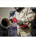 Badass Brushless Angle Grinder Set Featuring Dual High Output Batteries And Rapid Charger in use cutting metal pipe.