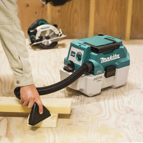 XCV11Z 18V LXT Brushless Cordless 2-Gallon HEPA Wet Dry Dust Extractor Vacuum in use on wood shop floor