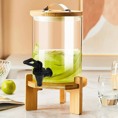 Heavy Duty Black Plastic Cooler Faucet And Reusable Spigot Tap With Leak Proof Seal For Water Buckets Party Coolers Beverage Dispenser on a glass drink dispenser.