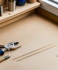 Two Brass Knife Pins for DIY Knife Handle Kits and Repairs, solid dowels with corrosion resistance on a workbench with pliers