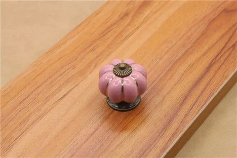 10 Pack Vintage Ceramic Pumpkin Cabinet Knobs In Sweet Pink Featuring A High Gloss Shine And Easy Peasy Install on wooden surface.