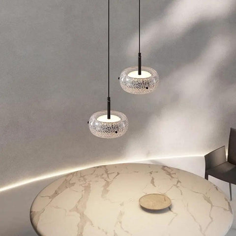 Resin Pendant Light, Gold 3 Color LED Hanging Fixture for Living Room illuminating a marble table with two stylish fixtures.