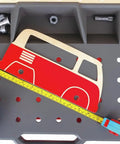 Vehicle Service And Repair Workbench Play Set With Realistic Tools For Young Builders Includes Drill Hammer Saw Wrench Tape Measure Bench Vice Gears Car Bodies Nuts And Bolts And Cardboard Garage Scene with car stencil and measuring tape on bench