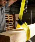 Worker using 2 Inch By 10 Foot Heavy Duty Lift Sling Web Strap With Wear Guard End And Flat Eye Reinforced Loops 15000 Lb Capacity