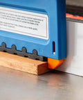 Slick D Handle Narrow Push Block For Table Saw Safety positioned over wood, showing non-slip base and tailhook design.