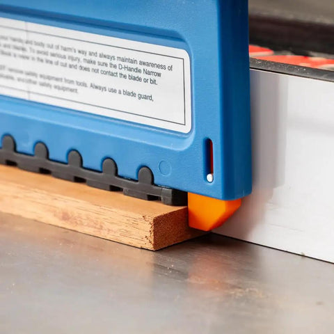 Slick D Handle Narrow Push Block For Table Saw Safety positioned over wood, showing non-slip base and tailhook design.