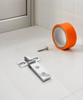 Stainless Steel Shower Door Pivot Hinge With Double Hole Design In 304 Bright Finish on tile floor with screw and tape