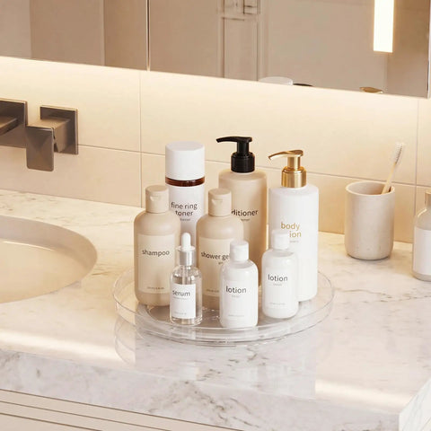 Smooth Spin Bathroom Vanity Tray For Counter 2 Pack 9 Inch Rotary Makeup Organizer with skincare products on marble countertop.