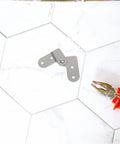 Heavy Duty Folding Hinge Kit For Tables And Ladders, shown with pliers on a tiled surface, galvanized steel hinge