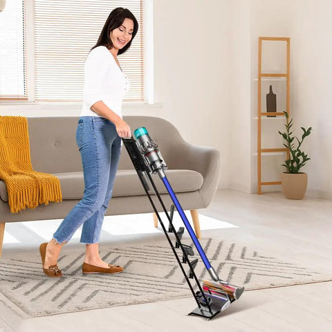 Woman using Vacuum Stand For Dyson V15 V11 V10 V8 V7 V6 Handheld Cordless Vacuums With Wheels in living room.