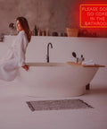 Bathroom with "Please Dont Do Coke in the Bathroom" neon sign, red 40x27cm on acrylic backplate, above a freestanding tub.