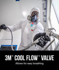 Worker wearing Half Face Organic Vapor Respirator P95 with Cool Flow Valve and protective suit, using spray equipment on worksite.