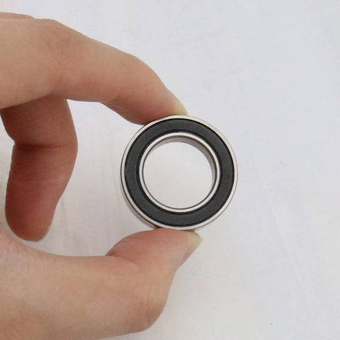 Hand holding Two Pack 17287-2RS Deep Groove Ball Bearings 17x28x7mm Steel With Black Sealed Covers For Cycling MTB Mountain Road Bikes