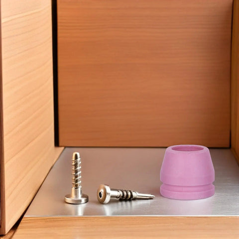 Rock Solid Plasma Cutter Consumables Kit With Ag60 And Sg55 Electrode Nozzle Set on a metal surface with screws and a pink nozzle.