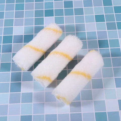 Three mini foam paint roller sleeves in white and yellow, part of the 30 Piece Mini Foam Paint Roller Sleeve Refill Set For Interior Walls Doors And Baseboards.