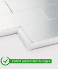 Close-up of DIY Friendly Self Adhesive Peel And Stick Trim For Walls And Borders Flexible Molding applied on tile edge.