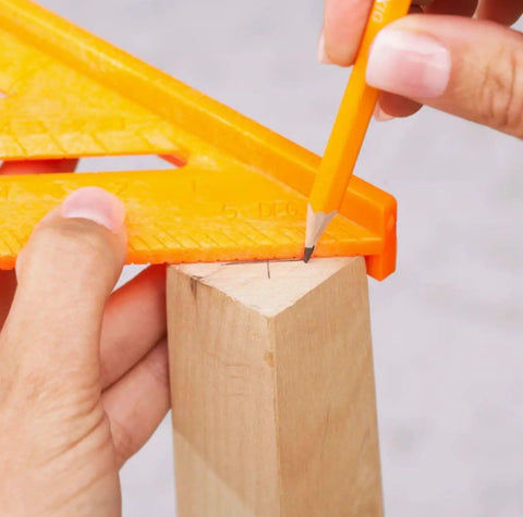 Hands using 8 Inch Orange Composite Speed Square Layout Tool With Center Line Guide Beveled Edge And One Eighth Inch Notches in action