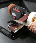 Badass Compact Desktop Electric Belt Sander Set For Sharpening Knives Metal Parts And Wood Projects With Adjustable Speed Settings And Comfortable Grip in action.