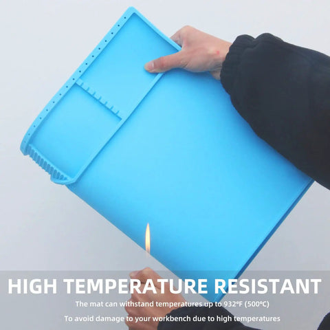 Large Silicone Solder Mat Heat Resistant To 932 F Magnetic Repair Surface with blue color, held by hand, demonstrating foldability.