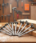 Meichoon 16-piece Forstner drill bit set, 15–35 mm, carbide steel bits, fanned on a wooden workbench.