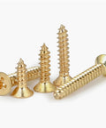 Boss Grade Pro Brass Countersunk Flat Head Phillips Self-Tapping Wood Screws M5x16, 10 Pack in a pile detail view.