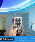 Hand holding 44 Key RGB LED Light Strip Controller With Infrared Remote For SMD 5050 2835 3528 Strips, adjusting ceiling lights.