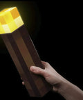 Hand holding Brownstone Torch Lamp 11.5 Inch LED Night Light With USB Charging Port Wall Mount Corner Piece Officially Licensed
