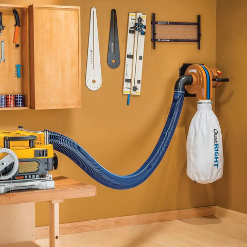 Hardcore 4 Inch Antistatic Dust Collection Hose With A Flexible Helix Ten Foot Layout connected to a dust extractor in a workshop.