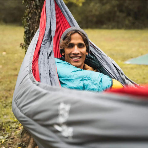 Person enjoying warm sleep with Ultralight Hammock Underquilt Insulated Camping Quilt For Warm Sleep Under Your Hammock.