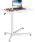 Slick Mobile Laptop Desk With Adjustable Height And No Sweat Rolling Casters Nifty Bedside Workstation With Rock Solid Frame Easy Move Setup For Tight Spaces And Chill Couch Reading Vibes Pristine White with laptop, phone, and magazines.