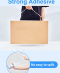 Person holding a sealed box with strong adhesive tape, showcasing Heavy Duty Packing Tape 12 Roll Set Clear 2.7 Mil.