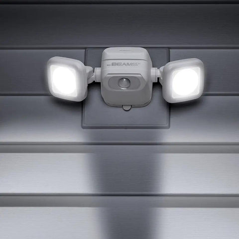 Netbright 500 Lumen Dual Head Wireless Battery Powered Motion Sensing LED Spotlight For Outdoor Security mounted on a wall