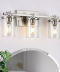 Three Light Vanity Lights In Brushed Copper Over Mirror With Clear Glass Shades For Bathroom Renovation Modern Farmhouse Rustic Chic Glow Powder Room And Hallway Lighting Fixture displayed above a round mirror