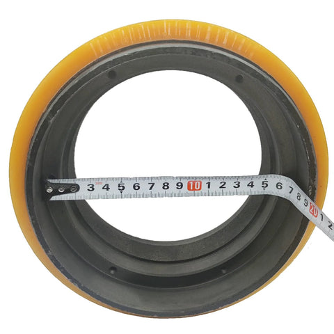 Drive Wheel Replacement 1115 220000 00 for Big Joe Electric Pallet Jack with smooth roll and durable build, shown with measuring tape.