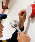 Right On Track Four Pack Flat Round Fire Sprinkler Cover Plates Slick Concealed Ceiling Caps being installed with a wrench.