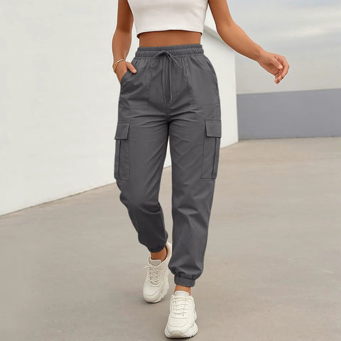 Woman wearing Women Lightweight Quick Dry Cargo Hiking Pants With High Waist Fit All Day Comfort Stretchy Parachute Style Baggy Travel Joggers.