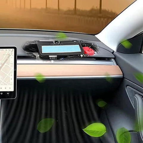 Close-up of installed 2 Pack HEPA Air Filter Replacement Kit For Model 3 Tesla, showing filter and intake grille blocking leaves.