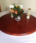 Top Shelf Natural Wood Lazy Susan Turntable Silent Swivel Serving Carousel With Heavy Hitter Load Capacity And Smooth Sailing Spin For Kitchen Island Setup And Party Spread on round wooden table with flowers.