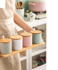 Top Shelf Ceramic Coffee Storage Jar With Secure Wooden Lid And Airtight Design Keeps Daily Grind Sugar Salt Tea Fresh As Ever While Looking Slick On Any Modern Counter Space, shown in a set of four.