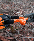 Go-To Lightweight Soft Shackle Set 1/2 Inch By 24 Inch Recovery Shackles With Sleeves For Sailing SUV Off Road Towing And ATV 56,000 Lbs Breaking Strength Orange 2 Pack shown in use on rugged terrain